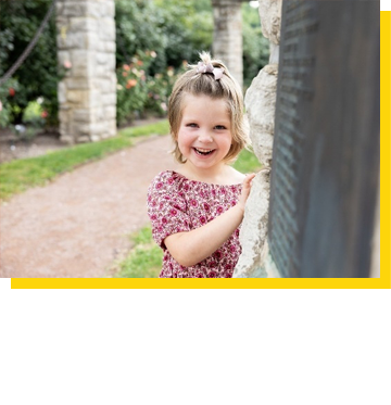 Photo of Olivia smiling in a park